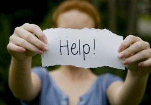 Image showing a women holding a sign for help