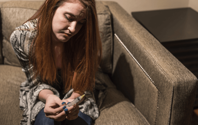 image showing a girl thinking to inject fentanyl